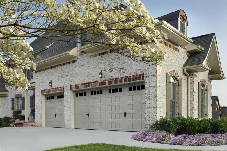 House with a garage door with recessed panels