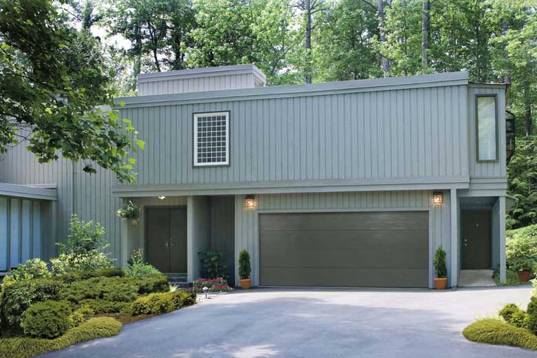 House with a garage door with flush panels