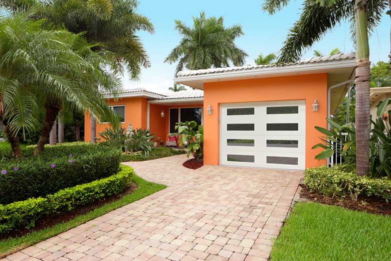 Orange house with a ribbed panel garage door
